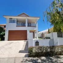 Same house after painting — fresh premium white exterior