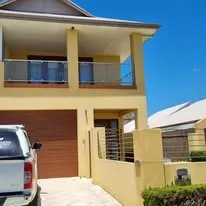 Two-storey rendered house before exterior repaint