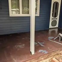 Verandah floor before — worn maroon surface